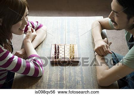 Young couple playing chess View Large Photo Image Stock Photograph - Young couple playing chess. Fotosearch