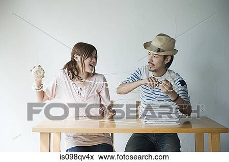 Young couple with string and magazines View Large Photo Image Stock Photo - Young couple with string and magazines. Fotosearch