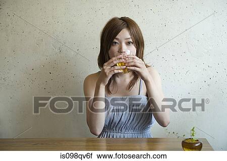Young woman drinking View Large Photo Image Stock Image - Young woman drinking. Fotosearch
