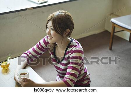 Young woman having tea View Large Photo Image Stock Photo - Young woman having tea. Fotosearch