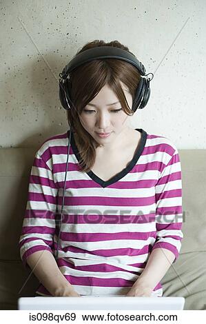 Young woman with headphones View Large Photo Image Stock Photo - Young woman with headphones. Fotosearch