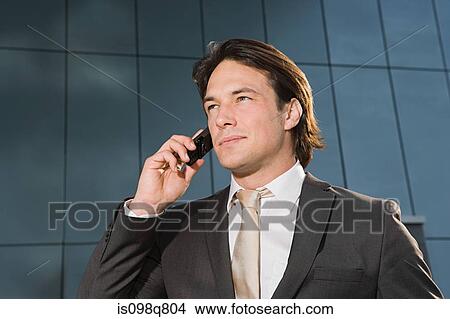 Businessman on cellphone View Large Photo Image Picture - Businessman on cellphone. Fotosearch