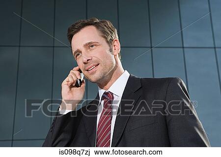 Businessman on cellphone View Large Photo Image Stock Image - Businessman on cellphone. Fotosearch