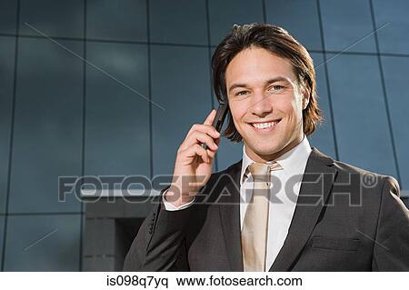 Businessman on cellphone View Large Photo Image Stock Photography - Businessman on cellphone. Fotosearch