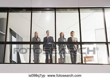 Businesspeople in office window View Large Photo Image Stock Photography - Businesspeople in office window. Fotosearch