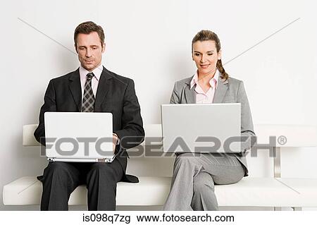 Stock Image - Businesspeople with laptops. Fotosearch
