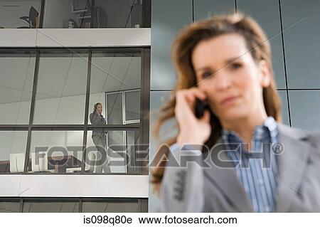Stock Image - Businesswoman on cellphone. Fotosearch