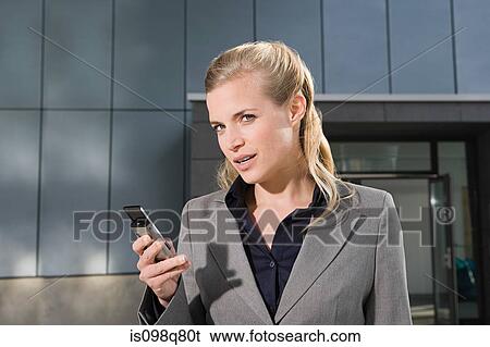 Stock Photograph - Businesswoman with cellphone. Fotosearch