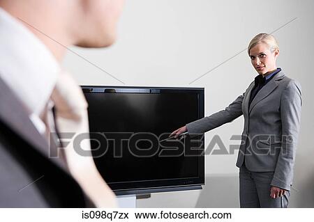 Stock Photo - Businesswoman with television. Fotosearch