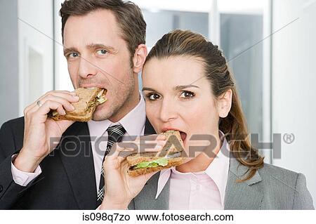 Colleagues eating sandwiches View Large Photo Image Picture - Colleagues eating sandwiches. Fotosearch