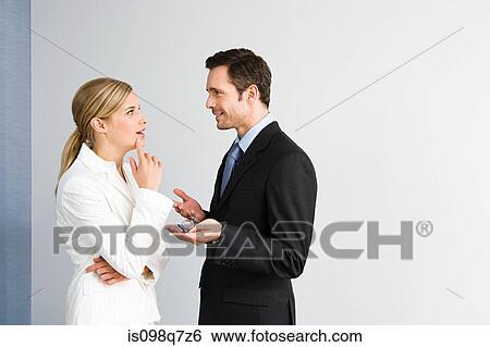 Stock Photograph - Colleagues having discussion. Fotosearch