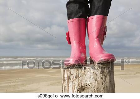 Child standing on a pole in boots View Large Photo Image Picture - Child standing on a pole in boots. Fotosearch