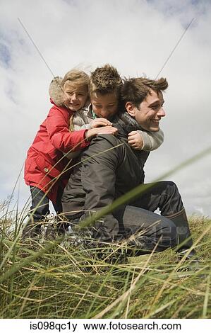 Stock Photo - Children and father outdoors. Fotosearch