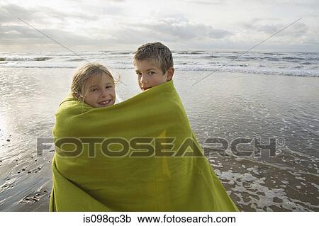 Children in blanket by the sea View Large Photo Image Stock Image - Children in blanket by the sea. Fotosearch
