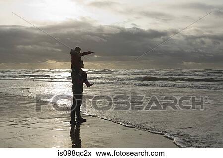 Stock Photo - Father and daughter by the sea. Fotosearch