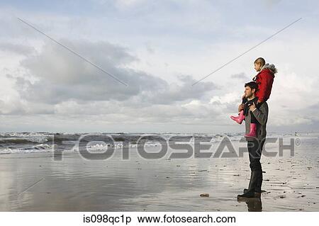 Stock Photography - Father and daughter by the sea. Fotosearch