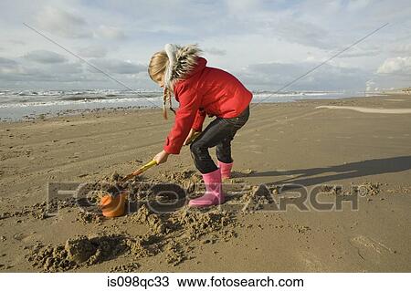 Girl playing with sand View Large Photo Image Stock Image - Girl playing with sand. Fotosearch