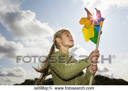 Stock Image - Girl with a pinwheel. Fotosearch