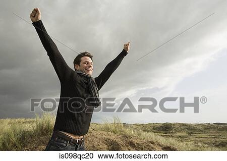 Man outdoors with arms raised View Large Photo Image Stock Image - Man outdoors with arms raised. Fotosearch