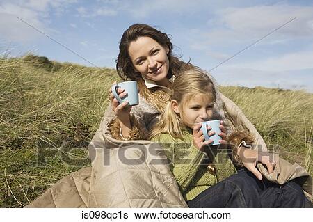 Mother and daughter outdoors with drinks View Large Photo Image Stock Photograph - Mother and daughter outdoors with drinks. Fotosearch
