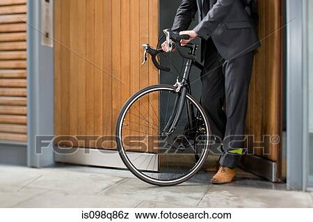Cyclist opening door View Large Photo Image Stock Photo - Cyclist opening door. Fotosearch