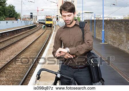 Stock Photo - Man at train station. Fotosearch