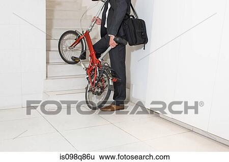 Man in office with bike View Large Photo Image Stock Photograph - Man in office with bike. Fotosearch