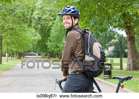 Stock Photography - Man in park with bike. Fotosearch