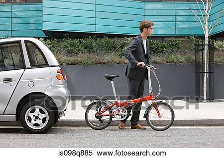 Stock Photography - Man with bicycle. Fotosearch