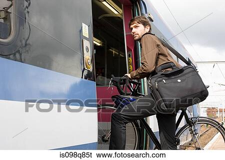 Man with bike getting onto train View Large Photo Image Stock Photograph - Man with bike getting onto train. Fotosearch