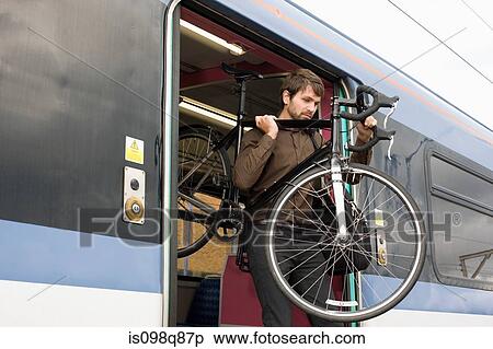 Man with bike on train View Large Photo Image Stock Photography - Man with bike on train. Fotosearch