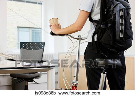 Person in office with bike View Large Photo Image Stock Image - Person in office with bike. Fotosearch