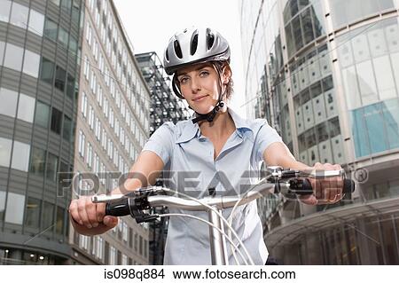 Woman cycling in city View Large Photo Image Picture - Woman cycling in city. Fotosearch