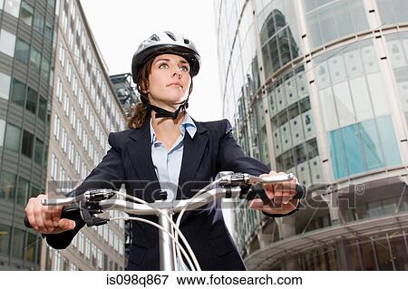Woman cycling in city View Large Photo Image Stock Photo - Woman cycling in city. Fotosearch