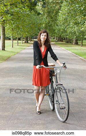 Woman in park with bike View Large Photo Image Stock Photography - Woman in park with bike. Fotosearch