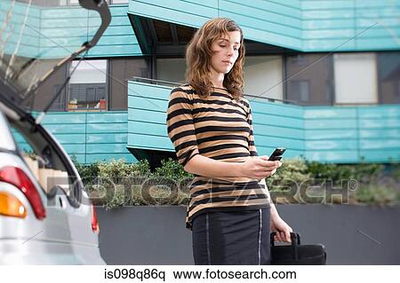 Woman looking at cellphone View Large Photo Image Stock Photography - Woman looking at cellphone. Fotosearch