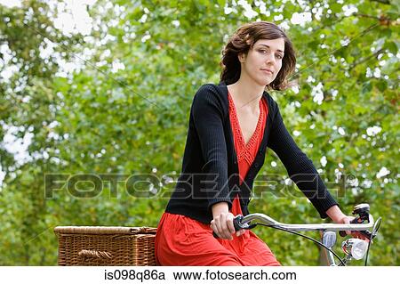 Stock Image - Woman riding bicycle. Fotosearch