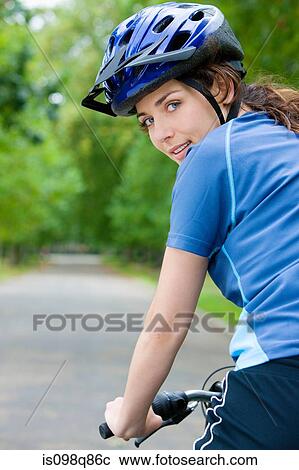 Stock Image - Woman riding bicycle. Fotosearch