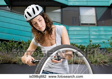 Woman suing bicycle pump View Large Photo Image Stock Image - Woman suing bicycle pump. Fotosearch