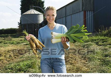 Woman holding vegetables View Large Photo Image Stock Photo - Woman holding vegetables. Fotosearch