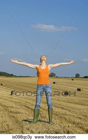 Stock Photo - Woman in a field. Fotosearch