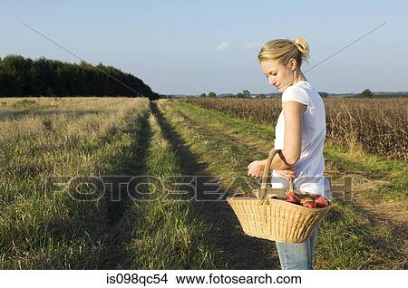 Woman in field with basket View Large Photo Image Picture - Woman in field with basket. Fotosearch