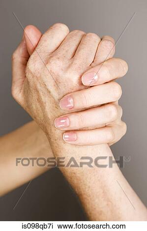 Stock Image - Hands on young and older women. Fotosearch