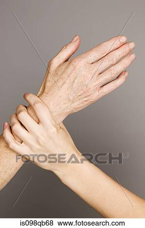 Stock Photo - Hands on young and older women. Fotosearch