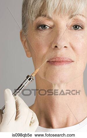 Woman having neurotoxin injection View Large Photo Image Stock Image - Woman having neurotoxin injection. Fotosearch