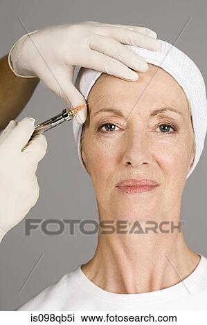 Woman having neurotoxin injection View Large Photo Image Stock Image - Woman having neurotoxin injection. Fotosearch