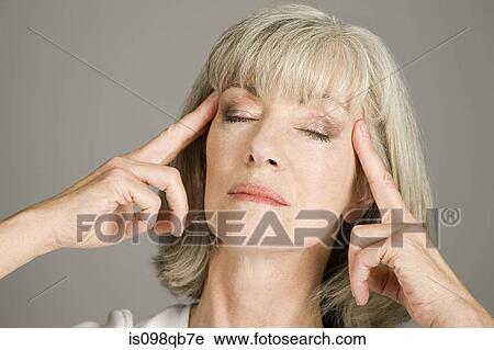 Stock Image - Woman massaging face. Fotosearch