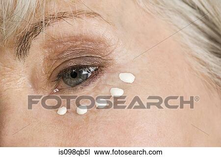 Woman with eye cream View Large Photo Image Stock Image - Woman with eye cream. Fotosearch