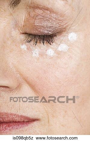 Woman with eye cream View Large Photo Image Stock Photo - Woman with eye cream. Fotosearch