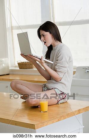 Angry woman looking at laptop View Large Photo Image Stock Image - Angry woman looking at laptop. Fotosearch
